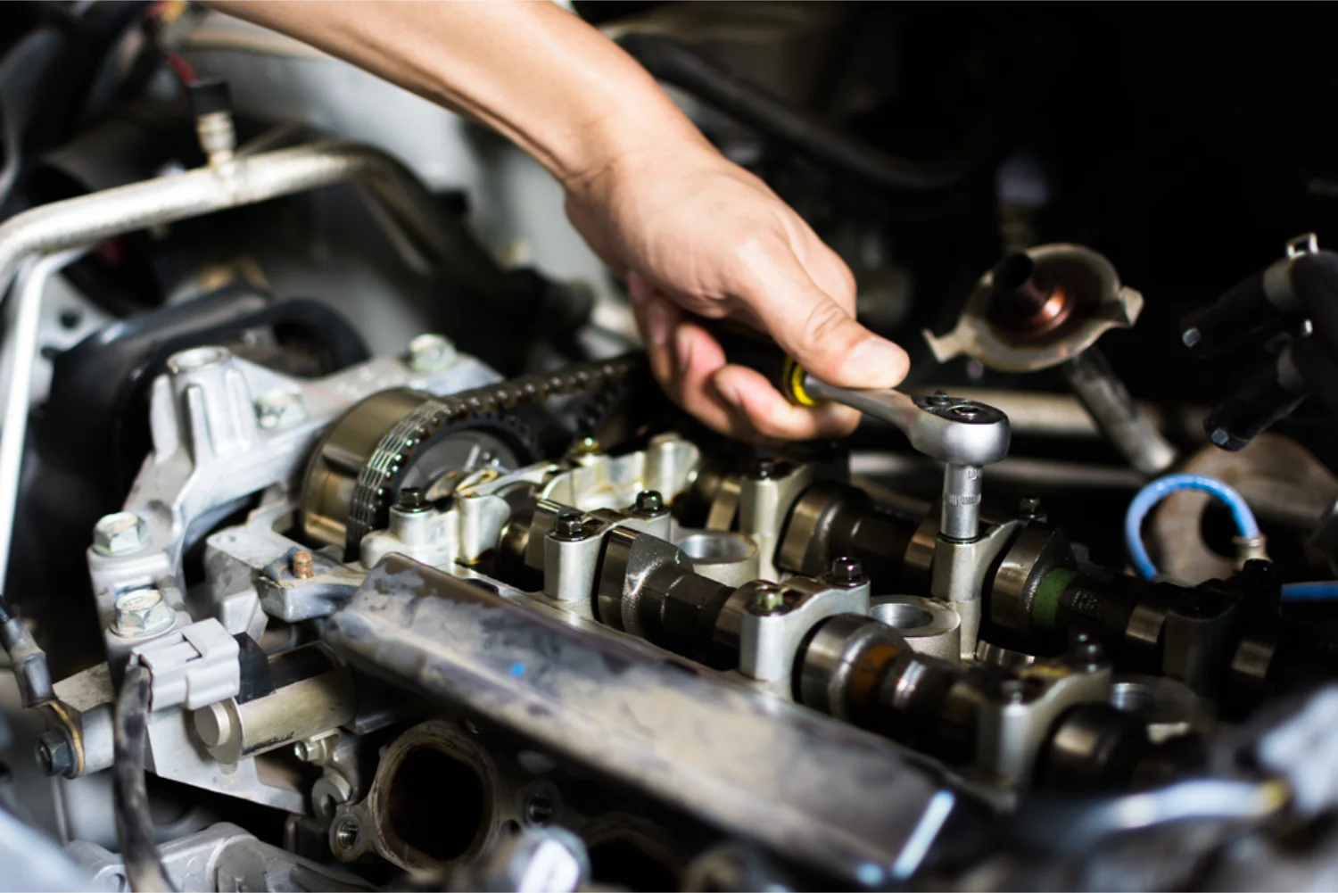 Mechanic working on engine timing components during a mechanical repair