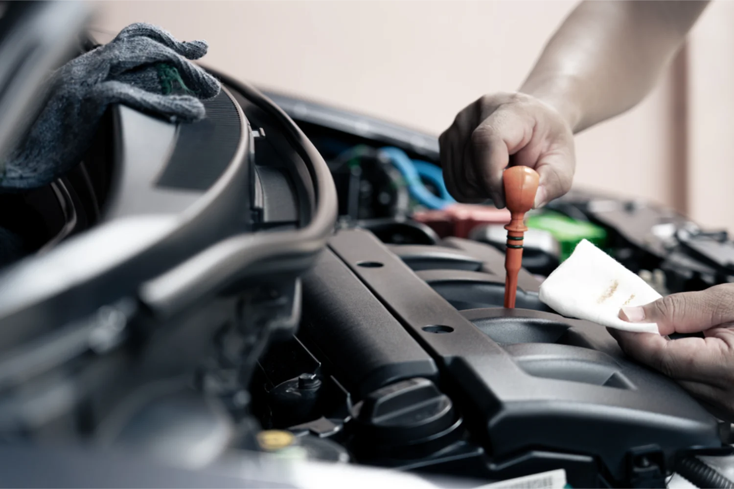 Mechanic checking engine oil as part of a logbook service