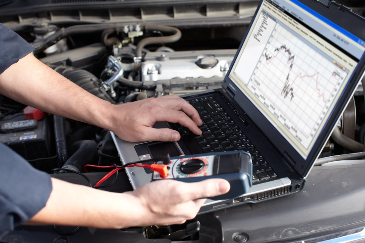 Mechanic running a computerised diagnostic scan on a vehicle engine
