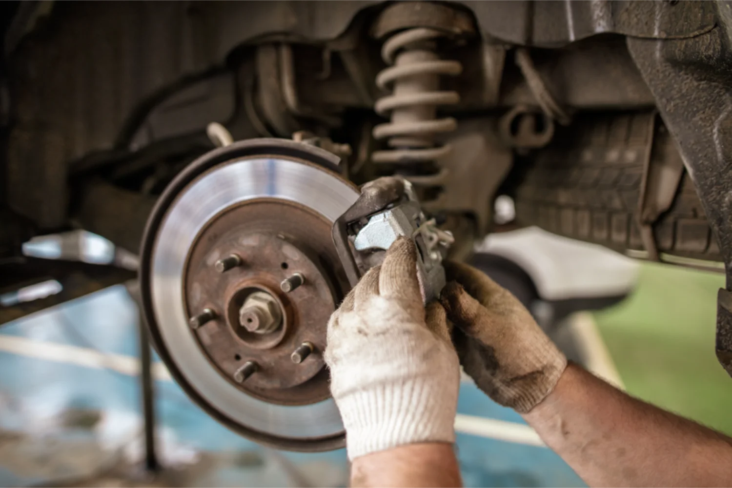Mechanic replacing brake pads on a vehicle